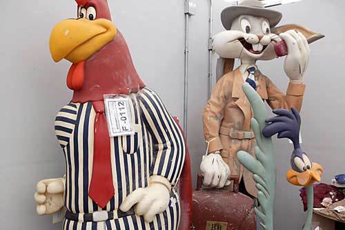 Close-up view of Looney Tunes ceramic figurines remaining upright and undamaged on store shelves in subgrade concourse